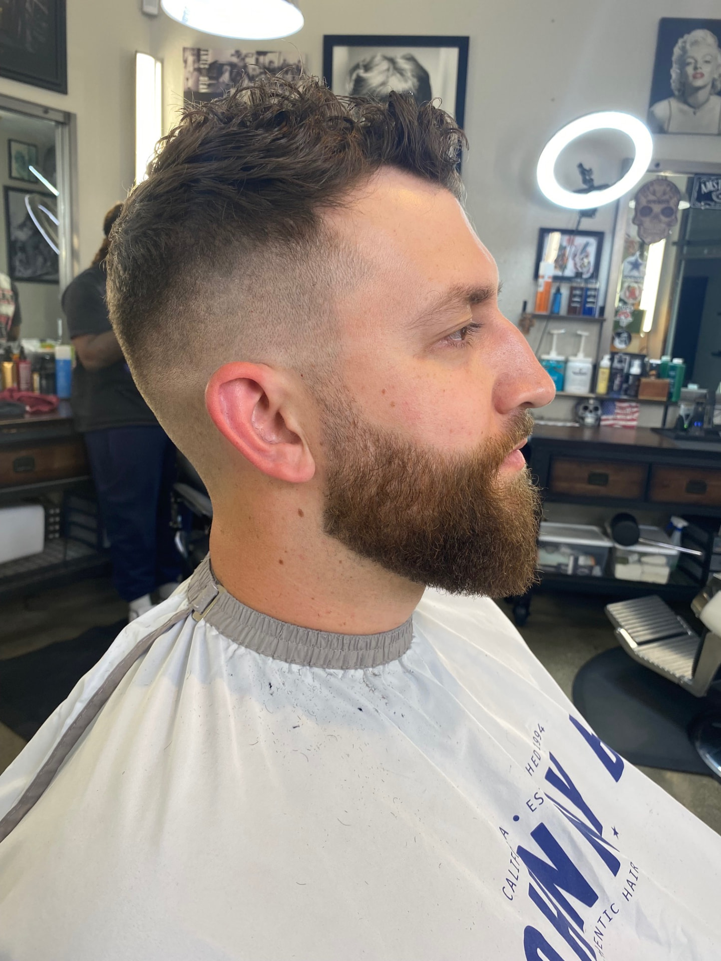 Textured haircut with a fade and beard trim by Ruben