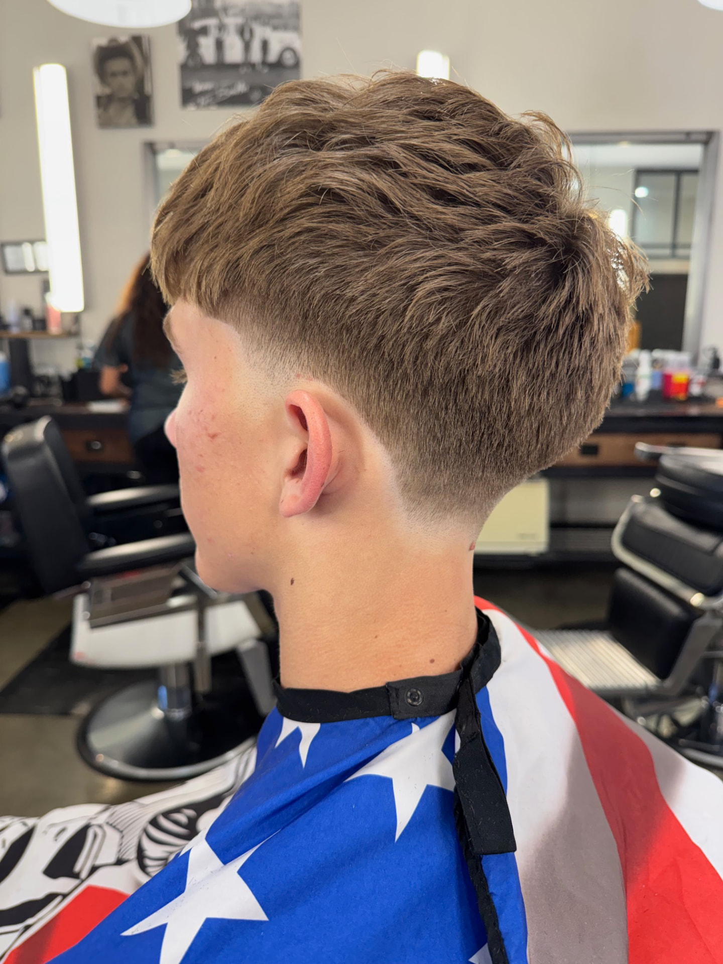 Textured haircut with a smooth taper by Madeline