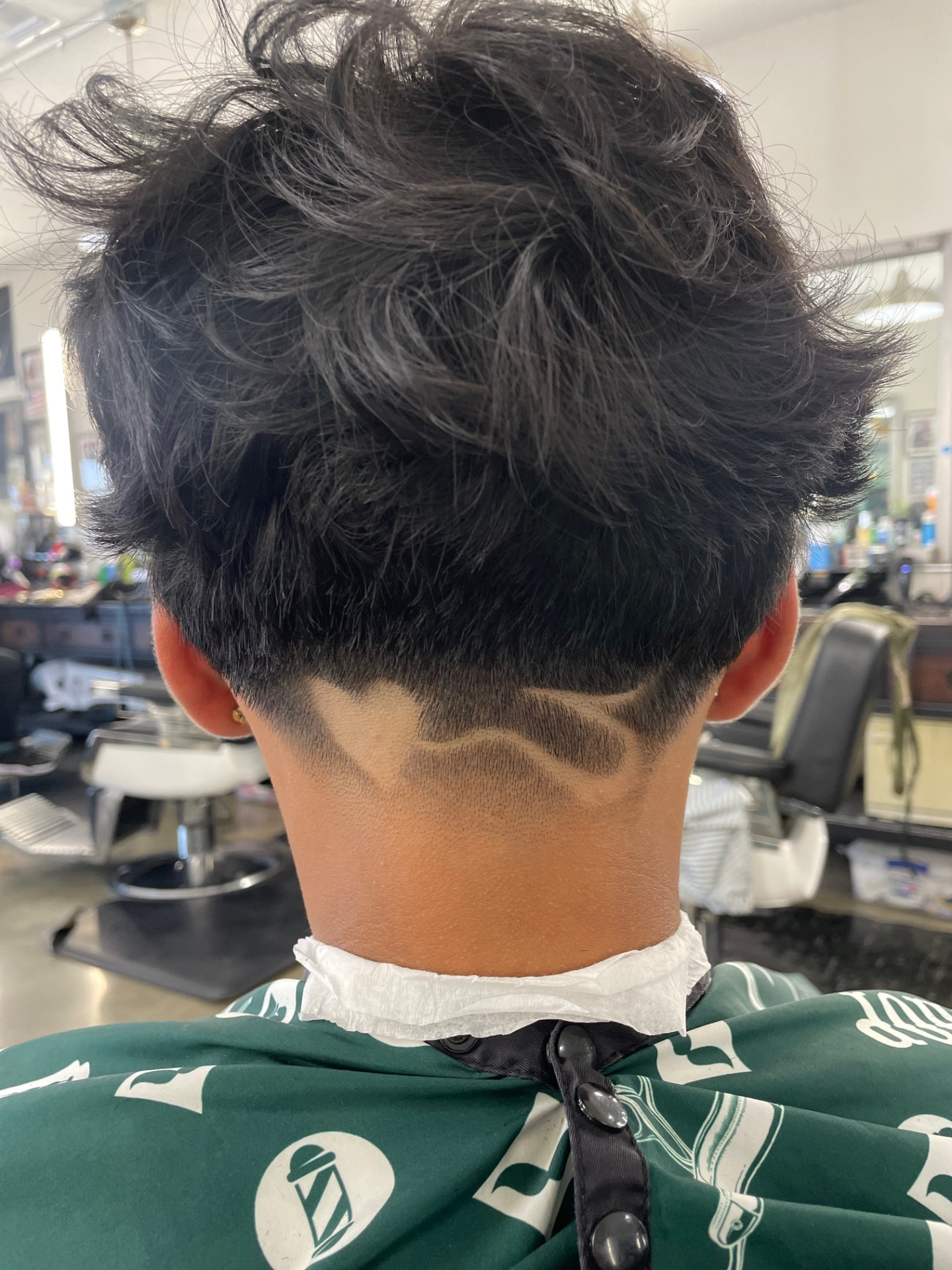 Neckline taper with a custom shaved design by Daniel
