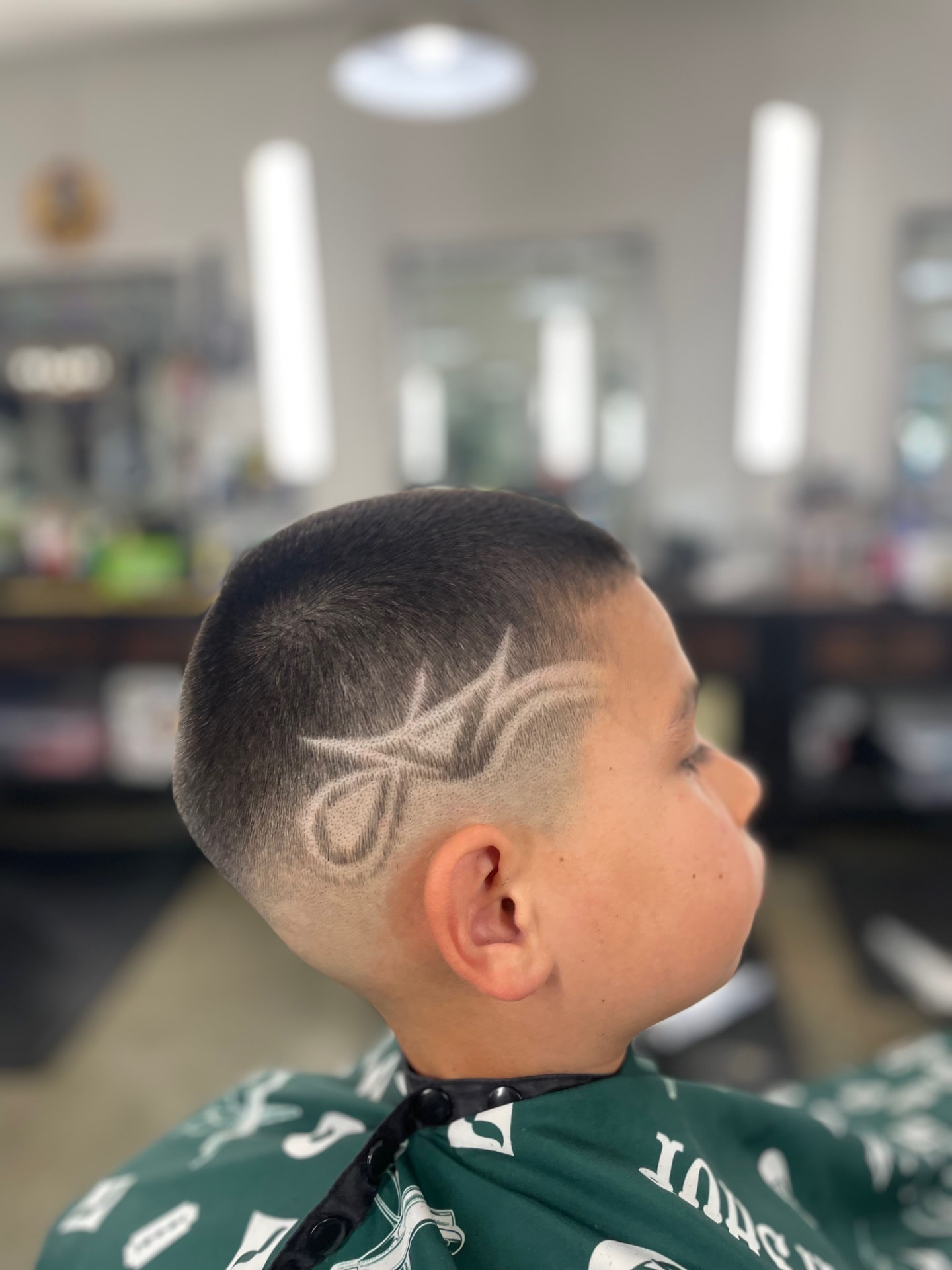 Children's haircut with a detailed shaved design by Daniel