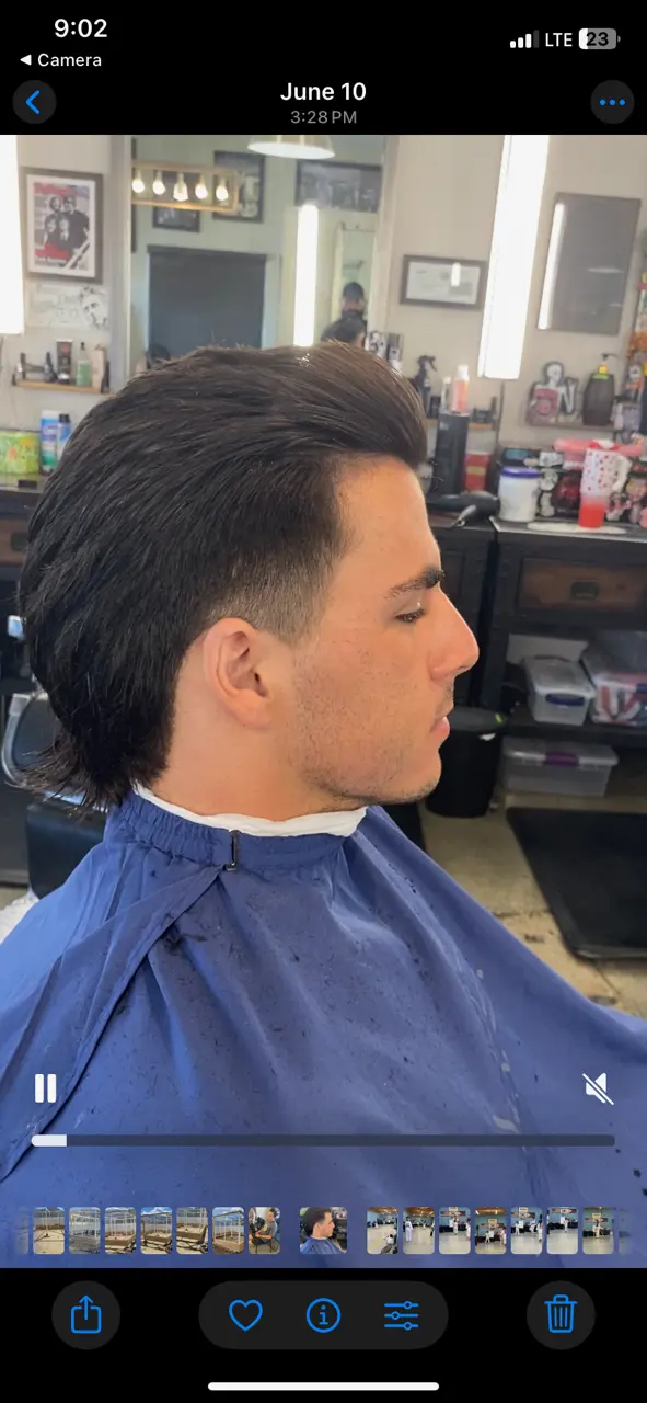 Modern mullet haircut with a clean taper by Ruben