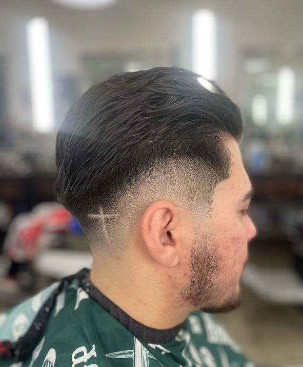 Classic comb-over fade with a shaved design by Daniel