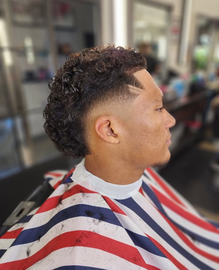Curly mohawk fade with a sharp lineup by Jerry
